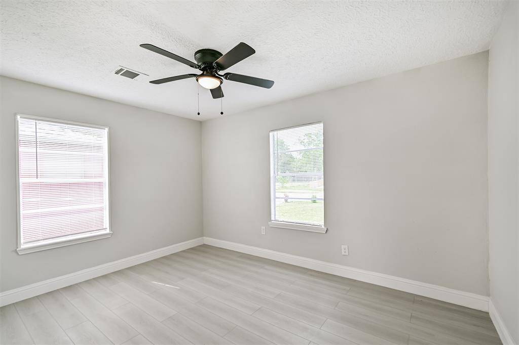 The bright and airy bedroom offers well-positioned windows that invite natural light and enhance the open feel of the space.
