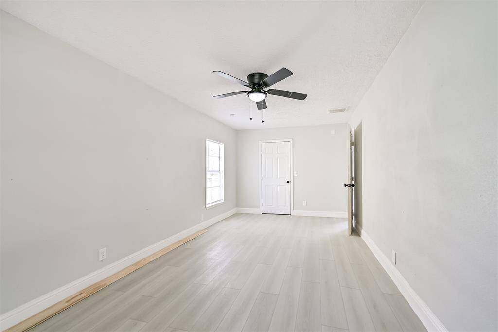 The secondary bedrooms offer functional, move-in ready comfort with updated flooring and modern lighting.