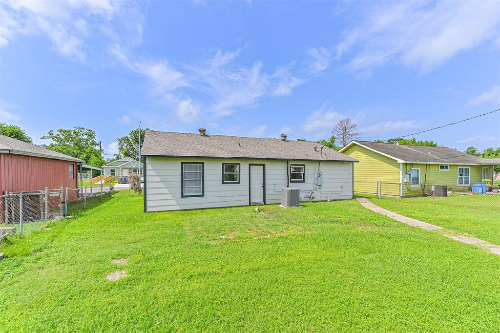 Enjoy a fully fenced backyard with a central pathway and updated HVAC unit, offering plenty of space for pets, play, or outdoor entertaining.