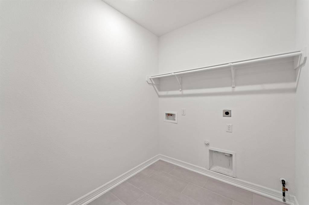 The laundry room layout is carefully planned for optimal workflow with designated areas for washing, drying, and storing.