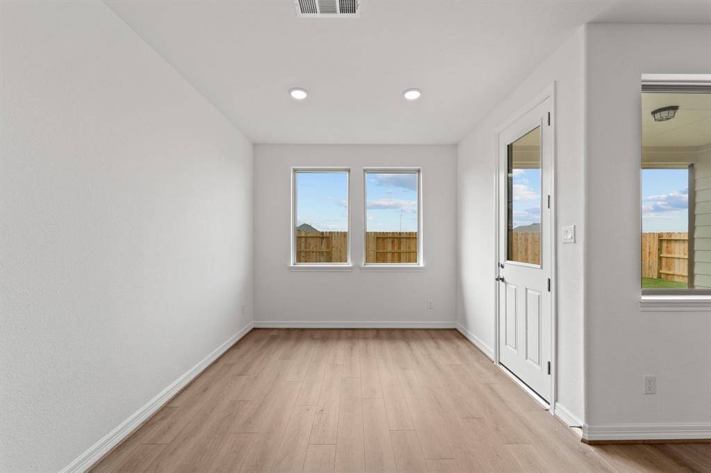 With an abundance of natural light streaming through the windows, the breakfast nook is bathed in a sunny glow, creating the perfect atmosphere to enjoy your morning coffee or a family breakfast.
