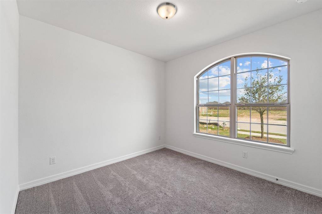 Your secondary bedroom features plush carpet, fresh paint, closet, and a large window that lets in plenty of natural lighting.