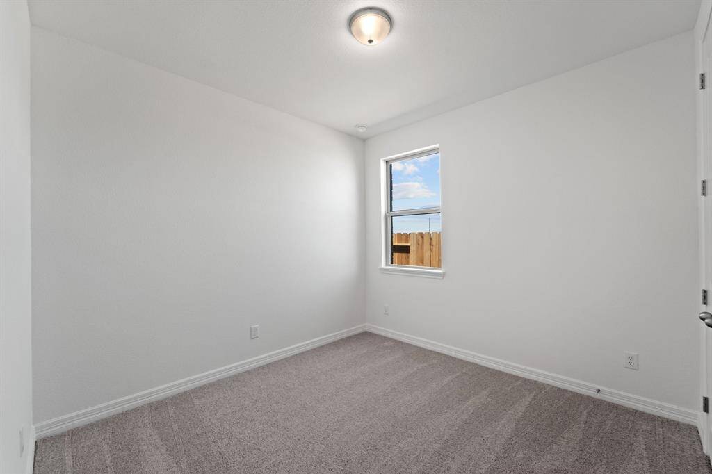 Your secondary bedroom features plush carpet, fresh paint, closet, and a large window that lets in plenty of natural lighting.