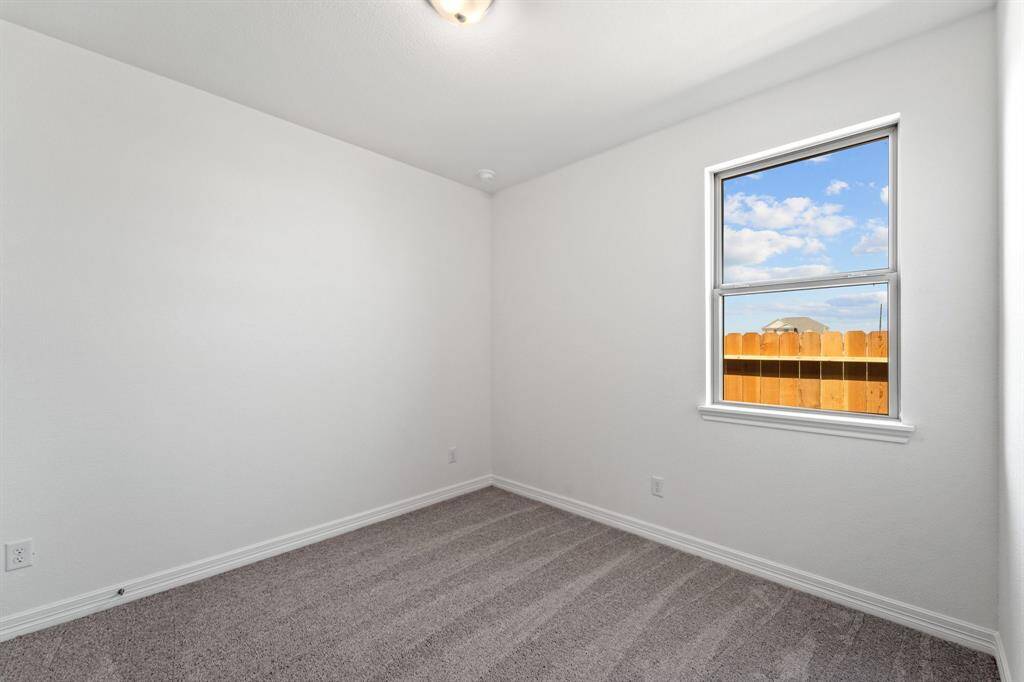 Your secondary bedroom features plush carpet, fresh paint, closet, and a large window that lets in plenty of natural lighting.