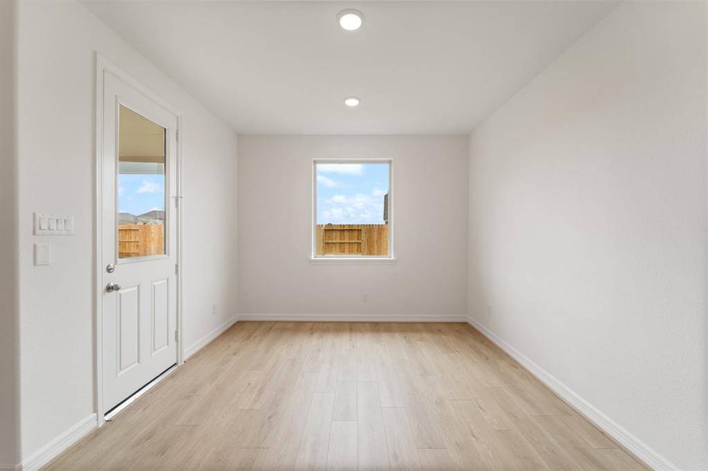 With an abundance of natural light streaming through the windows, the breakfast nook is bathed in a sunny glow, creating the perfect atmosphere to enjoy your morning coffee or a family breakfast.