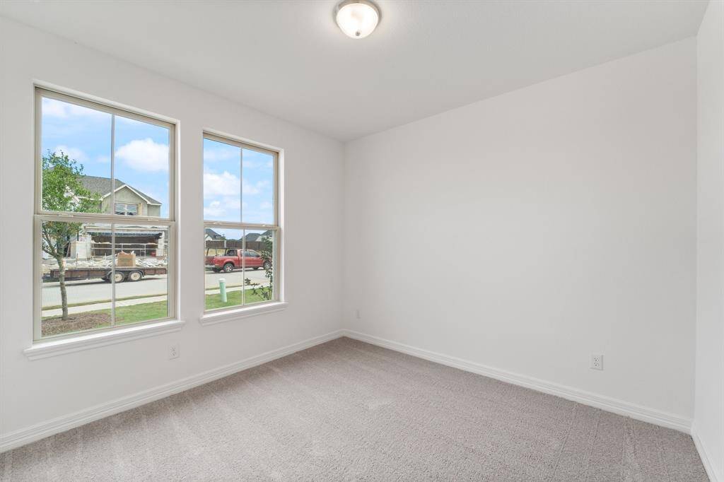 Your secondary bedroom features plush carpet, fresh paint, closet, and a large window that lets in plenty of natural lighting.