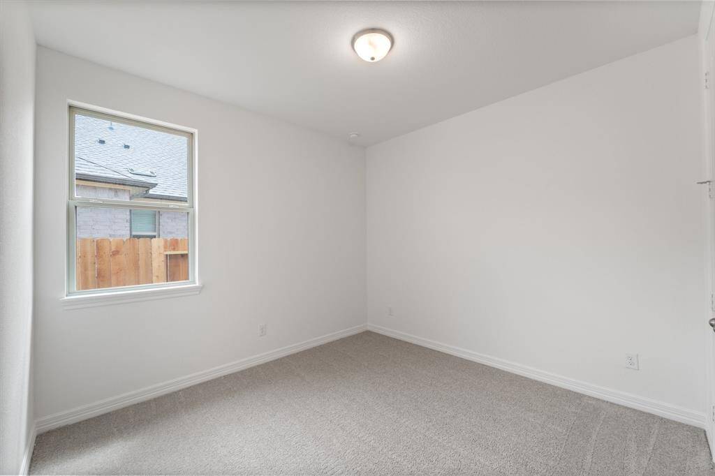 Your secondary bedroom features plush carpet, fresh paint, closet, and a large window that lets in plenty of natural lighting.