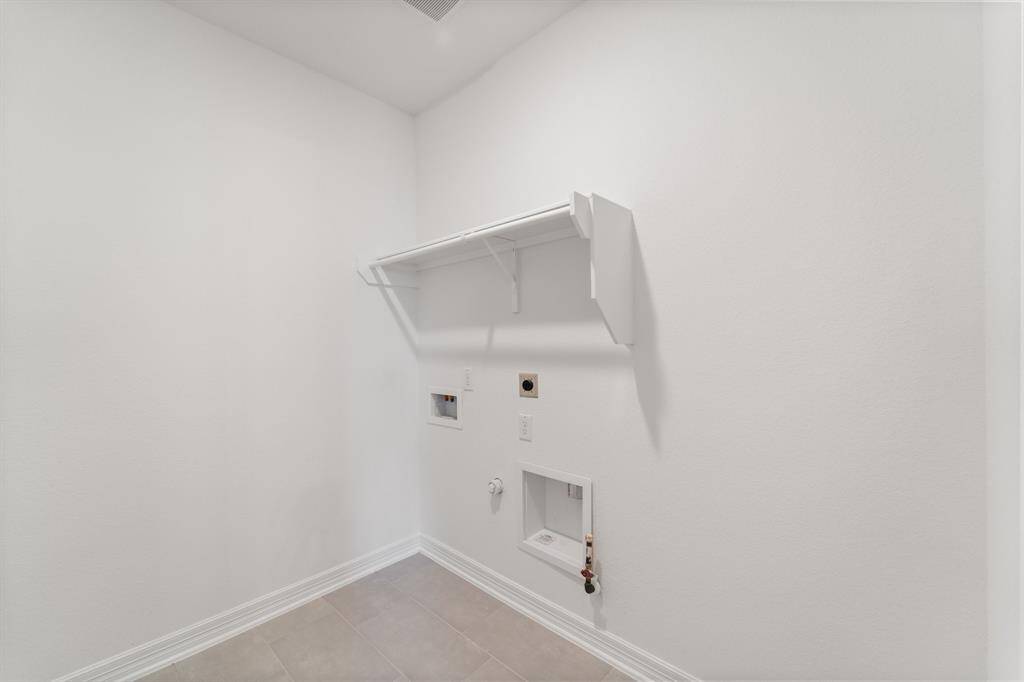 The laundry room layout is carefully planned for optimal workflow with designated areas for washing, drying, and storing.