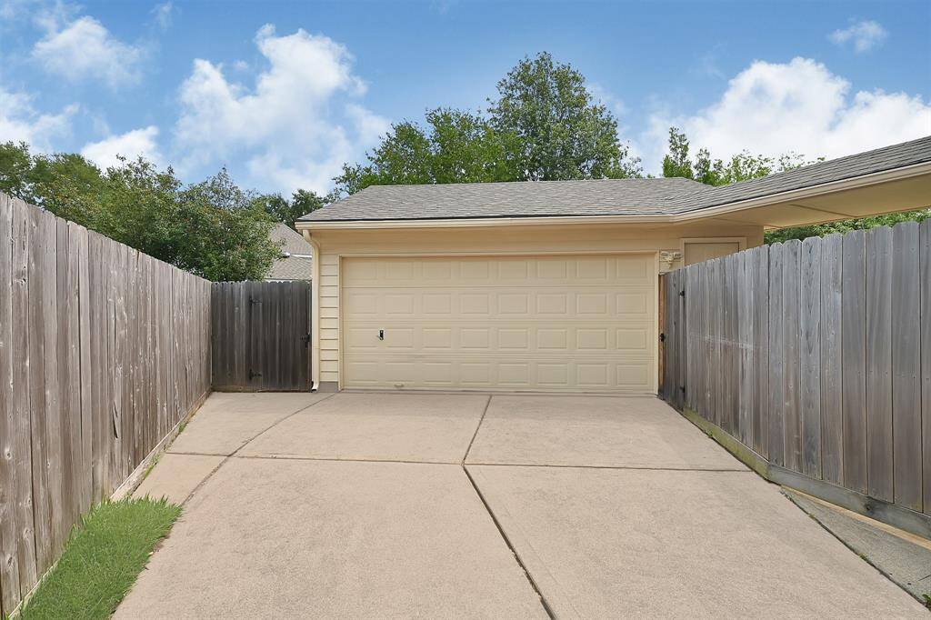 Private detached garage with a secure gated driveway offers extra privacy and versatile parking options. Ideal for weekend projects, storage, or working on your car.
