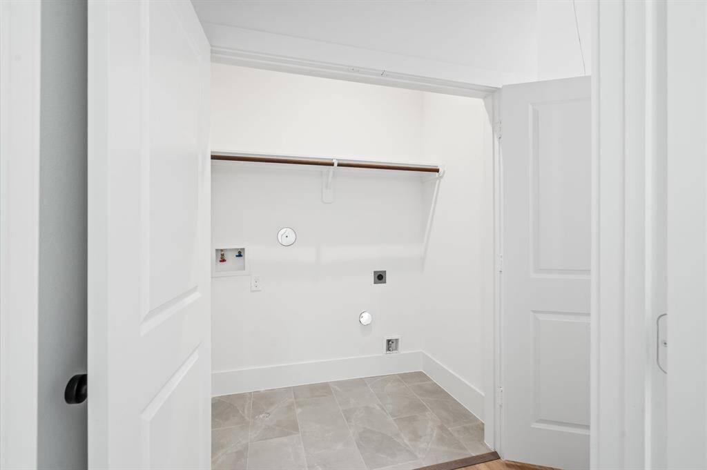 Tucked away on your way into the primary bedroom, this laundry closet can house a FULL sized washer and dryer. It is equipped with a shelf and rod system for sorting air-drying laundry, as well as providing a dedicated space for your laundry essentials! *All interior photos are from the model home: 5216 Pine Tree*