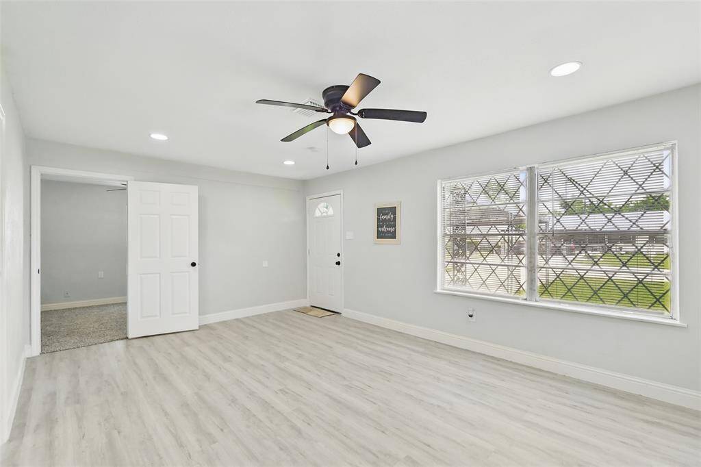 The living room offers well-positioned windows allowing natural light to pour in, creating a bright and welcoming environment
