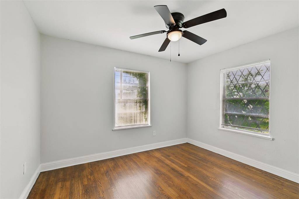 Dual windows and warm-toned LVP floors make this bedroom a bright and airy retreat.