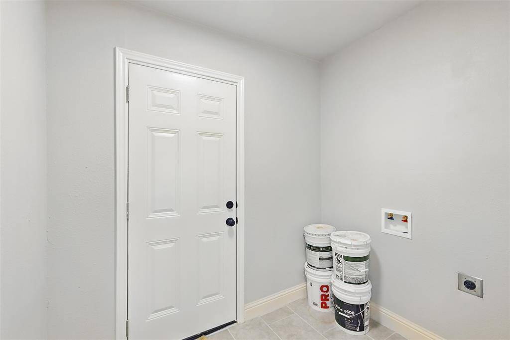This functional utility space offers tile flooring, built-in outlets, and ample room for full-sized laundry appliances—making laundry day simple and efficient.