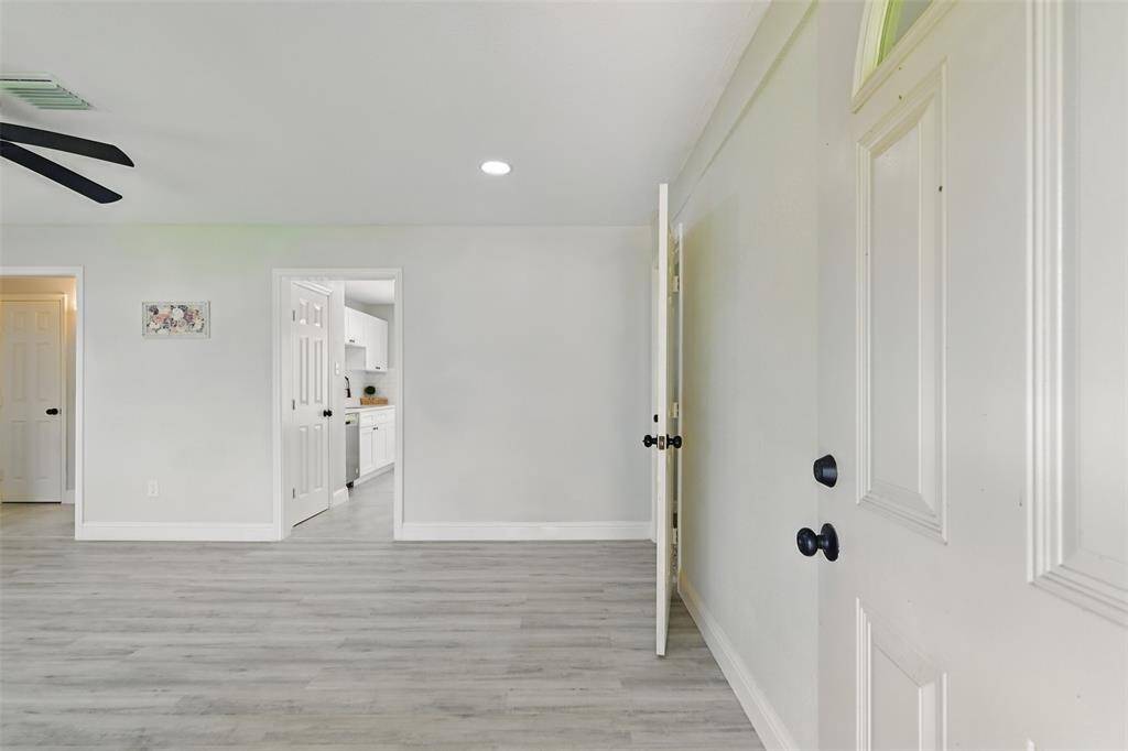 Step into the light-filled living room with durable luxury vinyl plank flooring, fresh grey interior paint, and an open layout designed for both relaxation and entertaining.