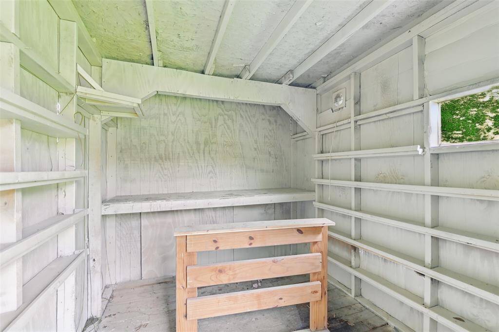 An inside look to the detached storage shed with built-in shelving is perfect for tools, hobbies, or gardening gear.
