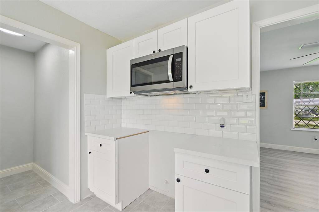 A suite of brand-new stainless steel appliances, including a dishwasher and microwave, offer both convenience and a polished, modern look.