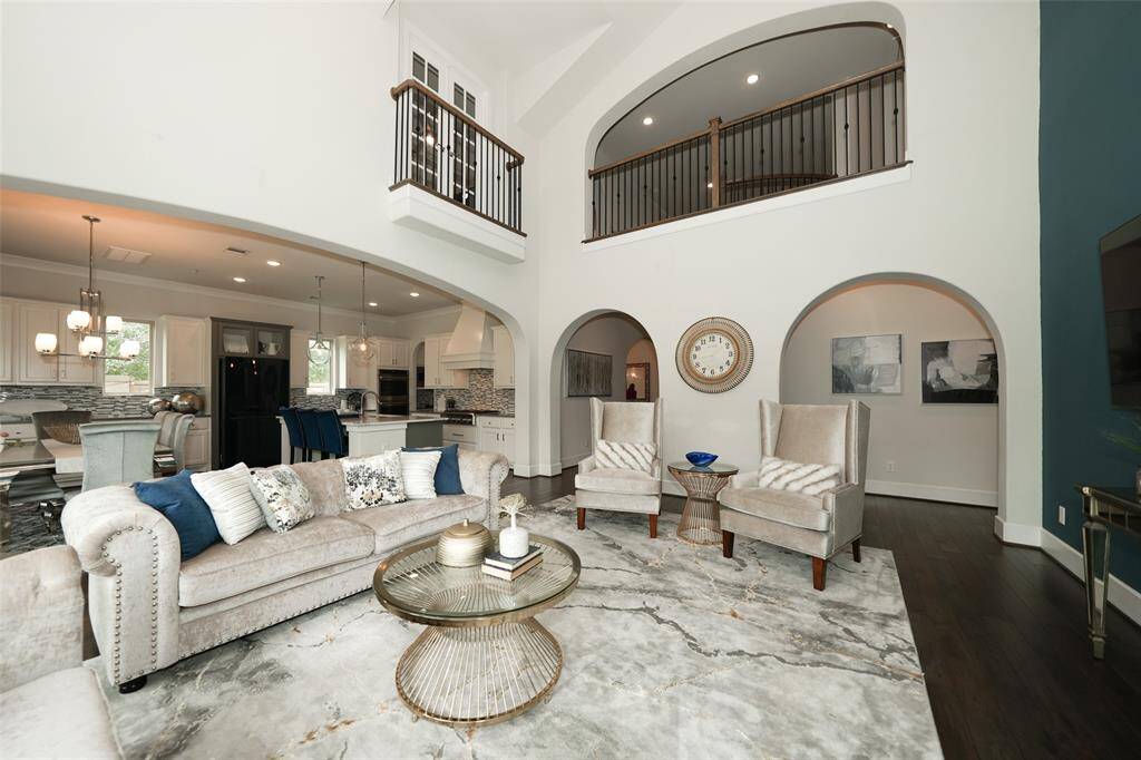Elegant view of the upstairs hallway and faux balcony from the spacious game room.