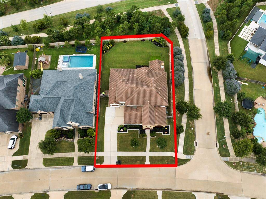 Expansive corner lot with a brick wall on two sides, offering a private backyard retreat.