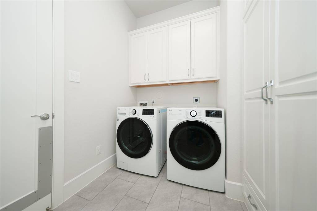Spacious laundry room with ample space for folding, sorting, and storage.