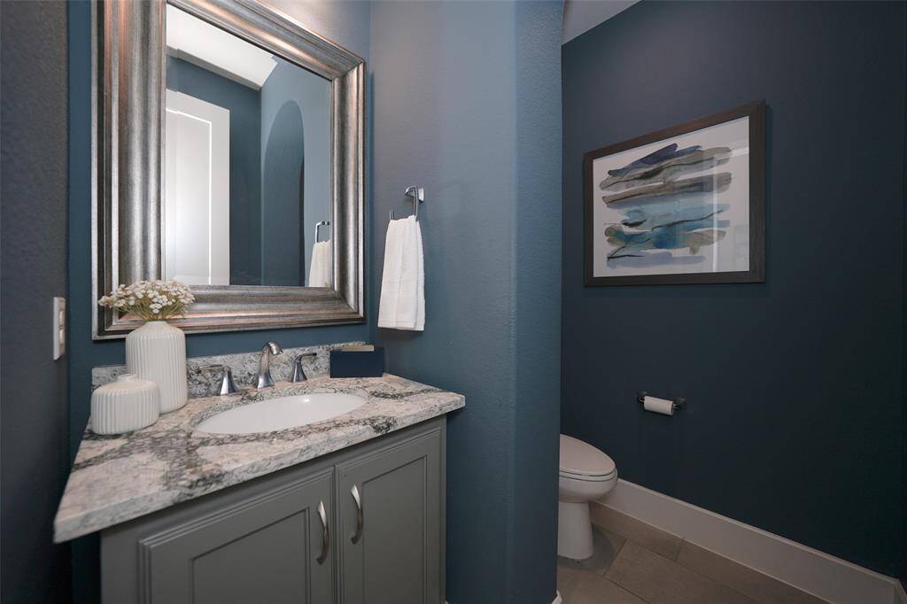 Elegant guest bathroom tucked away for privacy.
