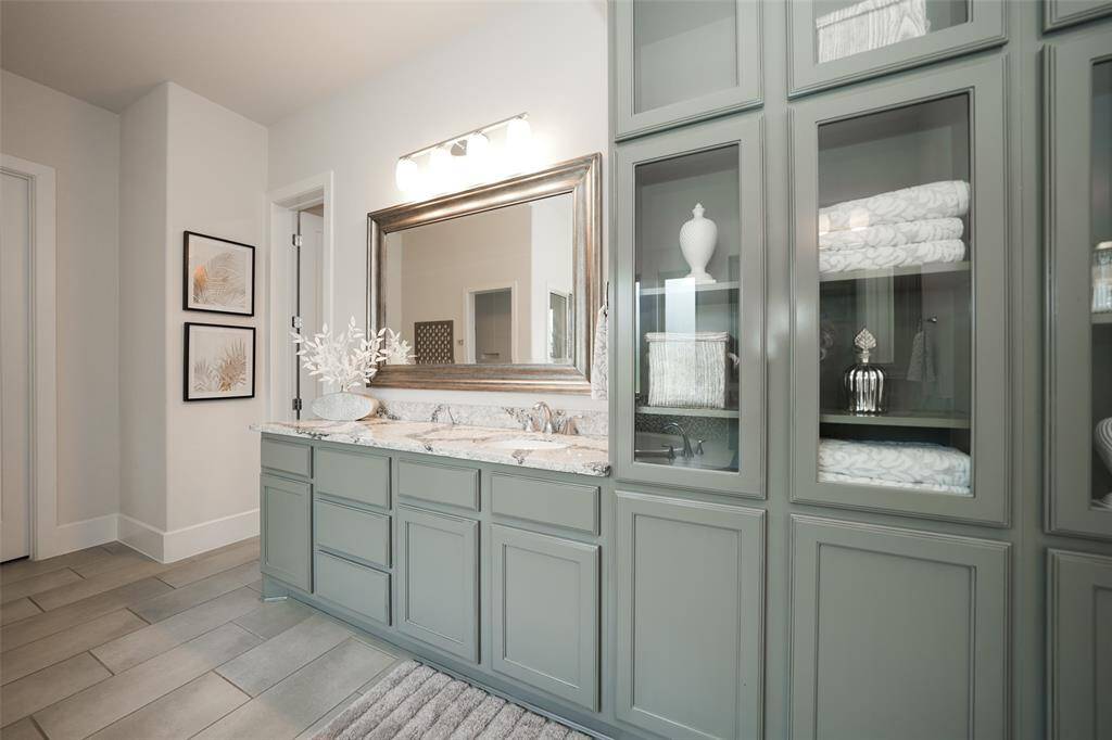 Elegant cabinetry enhances the space with its sleek design and ample storage, adding a touch of sophistication to the home.