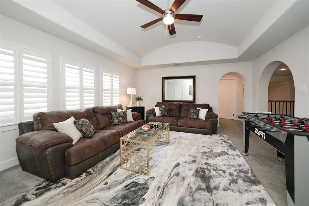 Discover a spacious game room upstairs, complete with built-in shelving in the closet and a faux balcony overlooking the family room. Enjoy ample space and a ceiling fan for comfort.