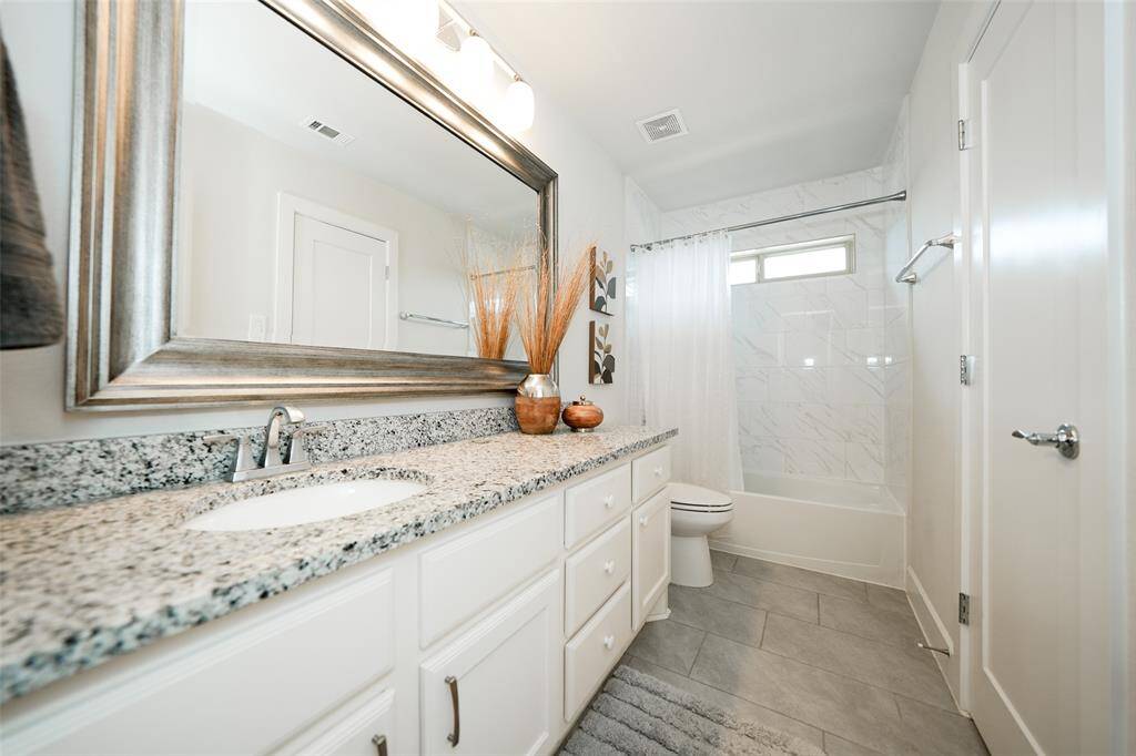 Spacious en suite bathroom with modern finishes.