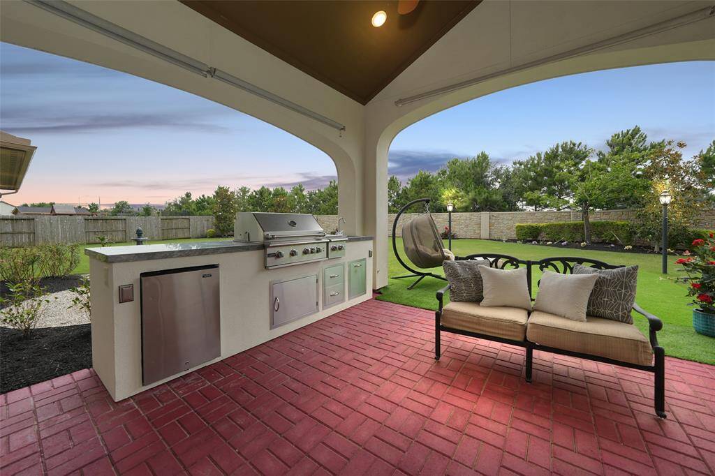 Experience outdoor living with a custom-built kitchen, perfect for summer BBQs and cozy fall evenings.