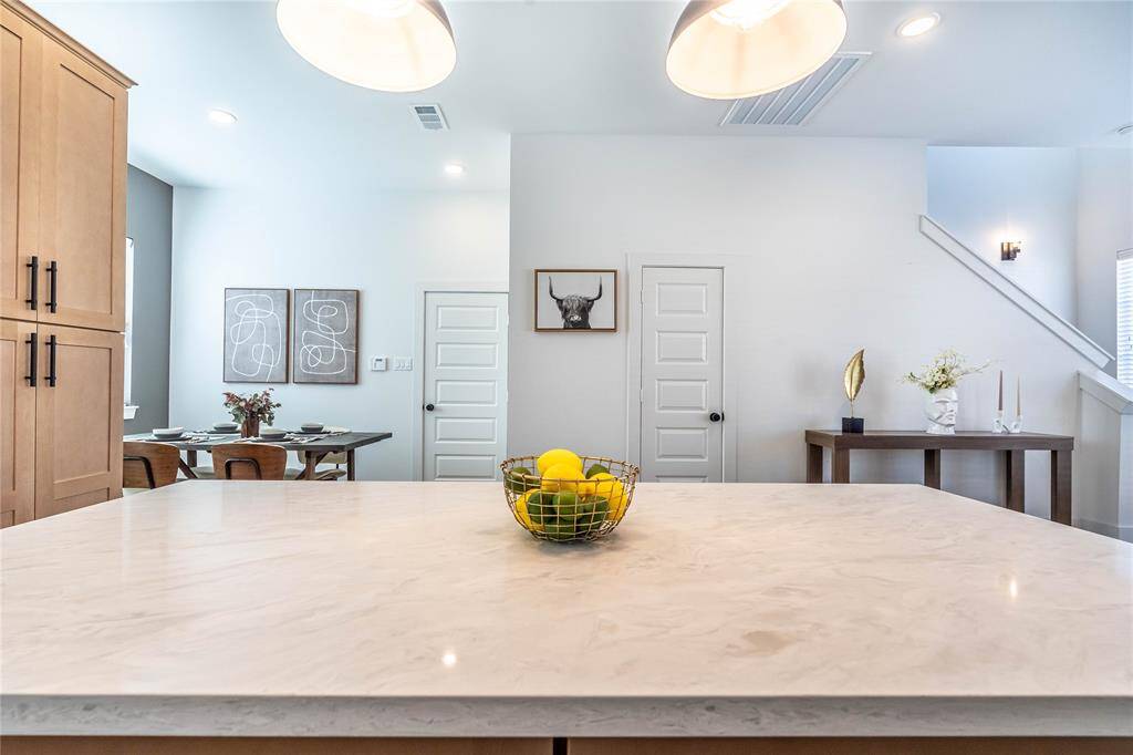 Expansive kitchen island offers ample space for meal preparation, casual dining, and entertaining, making it the heart of the kitchen.
