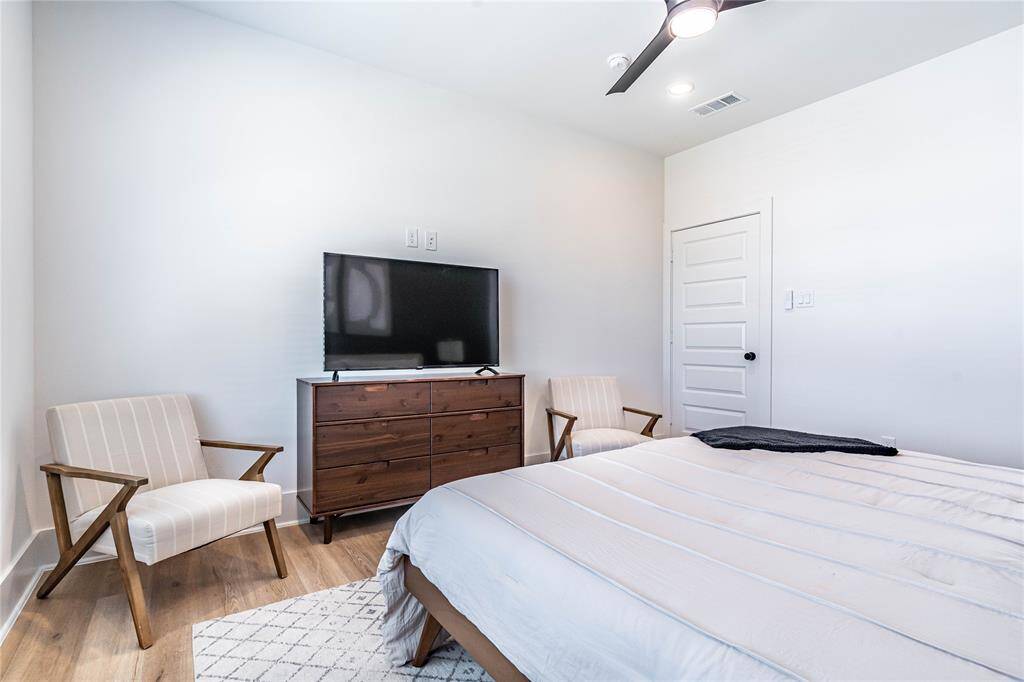 Primary bedroom provides plenty of space for a king size bed, night stands, a TV console and seating.