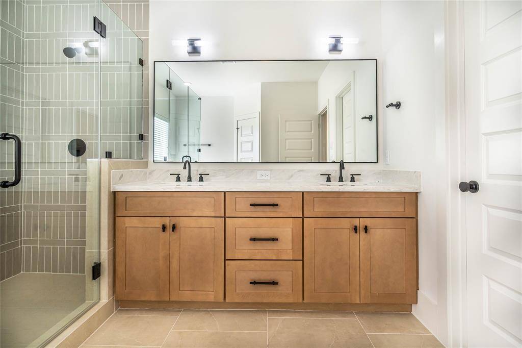 Plenty of storage of the well-designed vanity in the primary bathroom.