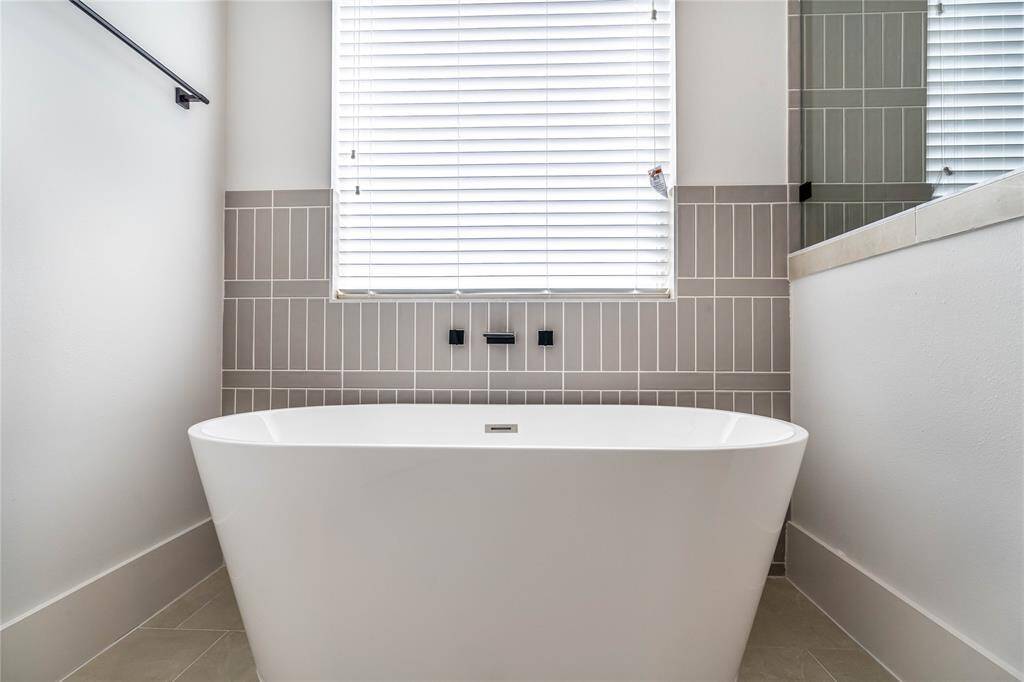 Soak in the tub and unwind after a long day, enjoying a moment of relaxation and tranquility.