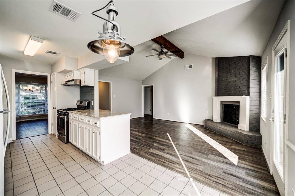 From the breakfast nook vantage point you get a close up of the stylish light fixture, and the nicely appointed kitchen.