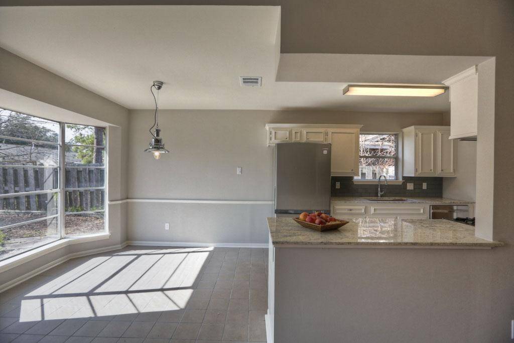 Breakfast nook has bay window and stylish light fixture!