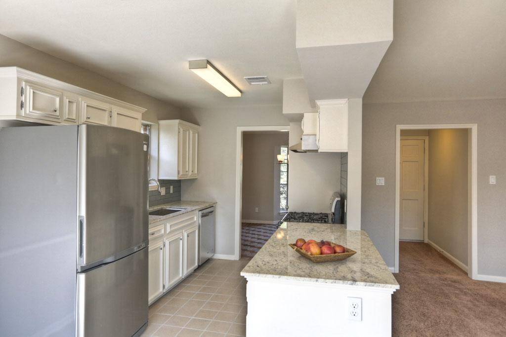 Stainless steel appliances and granite countertops.
