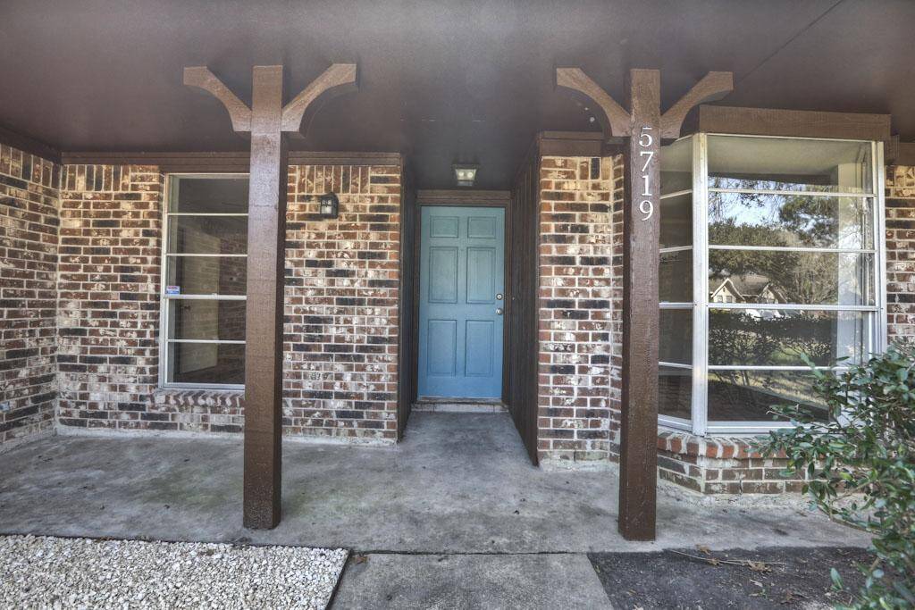 Soft blue door really pops against the rich colors. Inviting front porch for guests and your enjoyment.