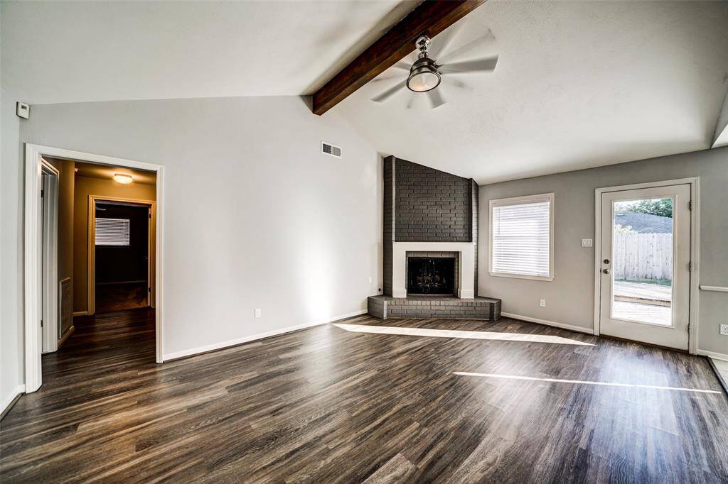 High ceilings and fireplace add to the appeal of this bright yet warm living room.