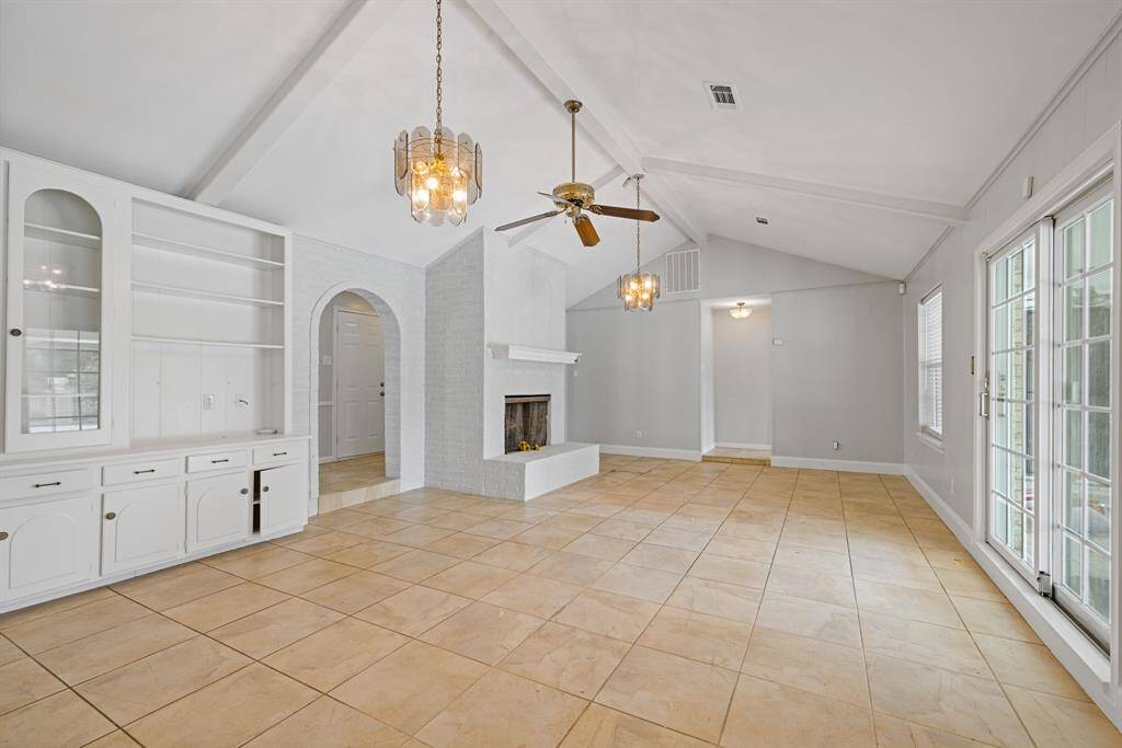 Beautiful cathedral ceiling in the family room adds to the big open concept living. This end of the family room is the primary bedroom access.