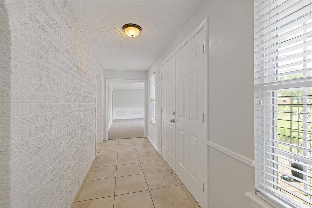 The home entry is very private! No one peering thru the front door! To the right of the front door is the formal living room/dining room. The the left of the front door leads to the secondary bedrooms and bathroom.