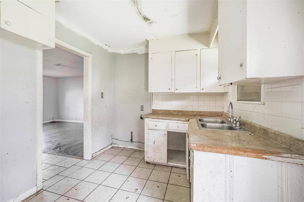 The current layout offers a pass-through feel—perfect for opening up to create a seamless flow from kitchen to living space. Investors can easily reimagine this as a central entertaining hub.