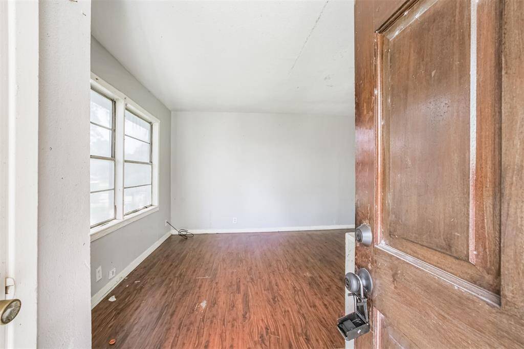 Step into a spacious main living area with great natural light from large windows. The layout is ready for an open-concept transformation.
