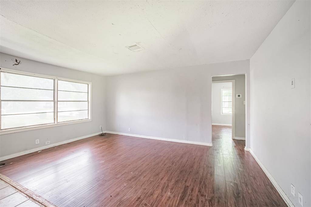 The combined living and dining area gives you flexibility to design a unified entertaining space. Large windows offer views to the oversized front yard.