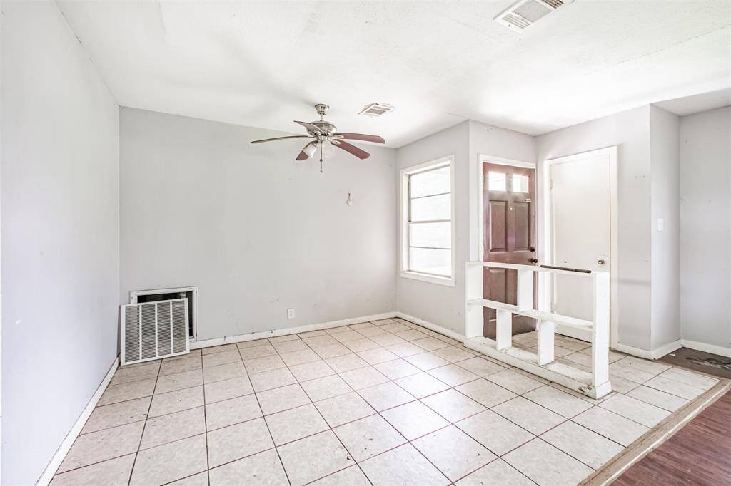 Tiled front entryway with natural light and ceiling fan. Customize this space into a stylish foyer or keep it open for a welcoming, functional drop zone.
