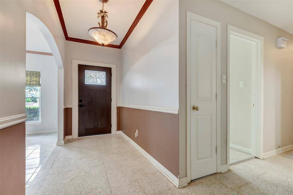Elegant terrazzo flooring enhances the front entry.