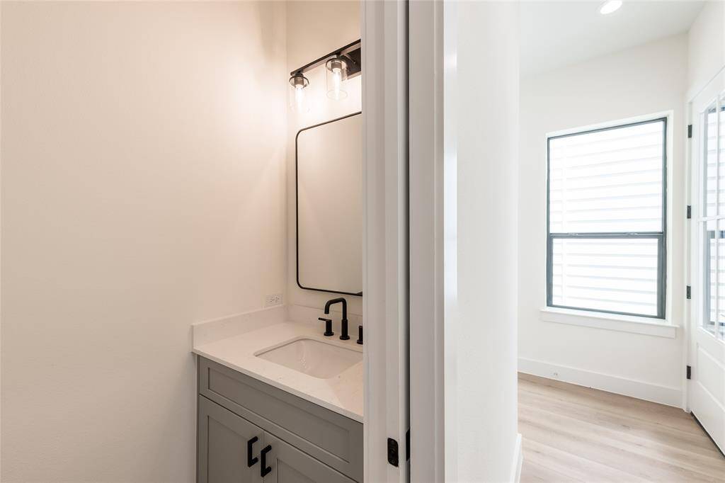 Convenient half bath on the first floor, featuring tasteful, modern selections that blend timeless style with everyday functionality.