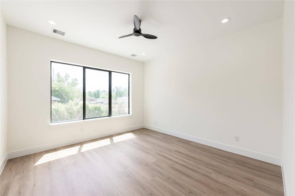 Bright and spacious primary bedroom filled with natural light, creating a warm and inviting retreat.