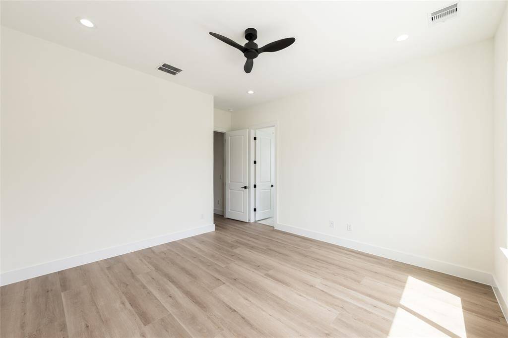 Alternate angle of the primary bedroom showcasing the entryway, offering a sense of flow and spaciousness throughout the suite