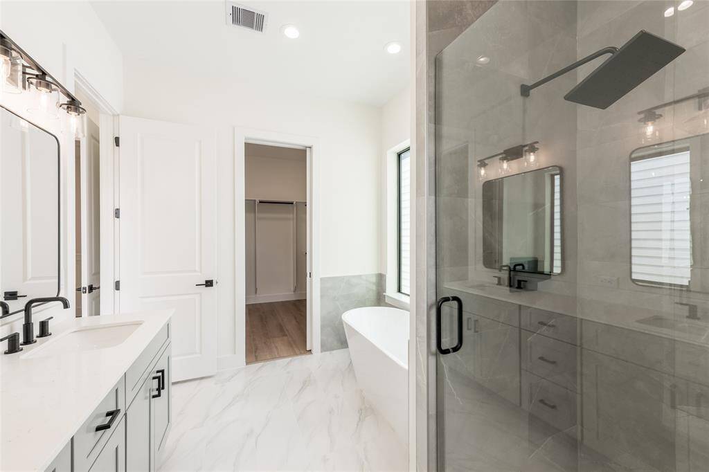 Sleek standing shower with a built-in seat and recessed niche for organized storage, beautifully finished with luxurious tilework for a spa-like experience.