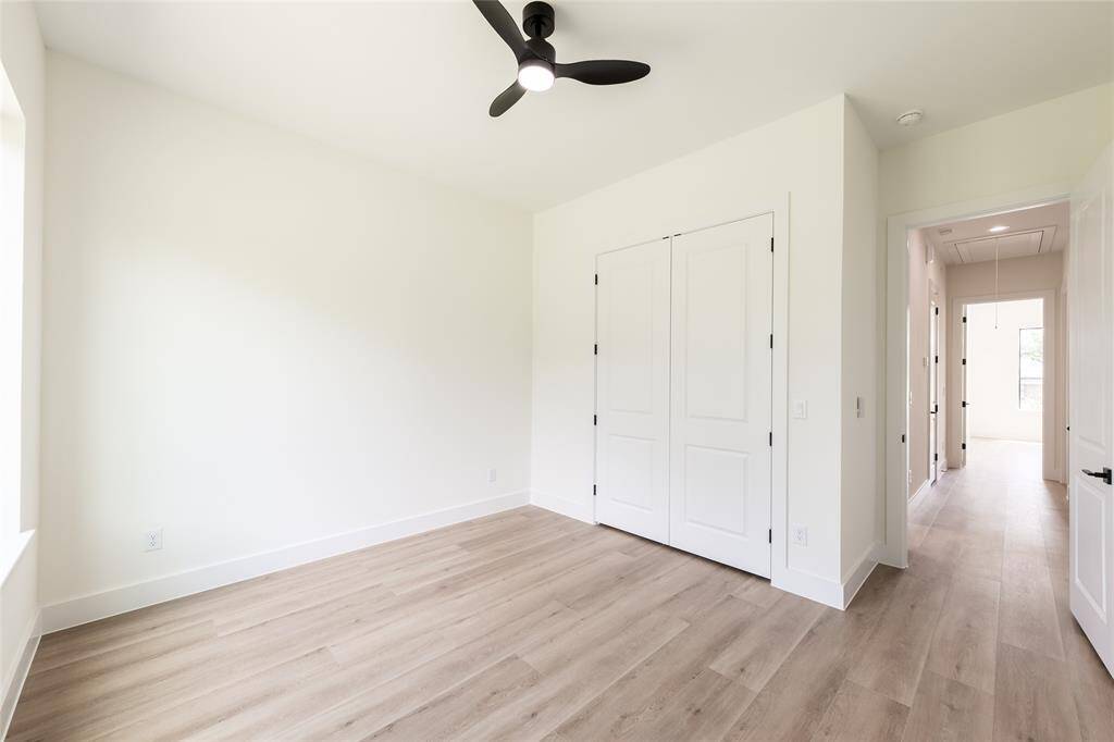 One of the generously sized secondary bedrooms, offering plenty of natural light and versatile space for relaxing or working.