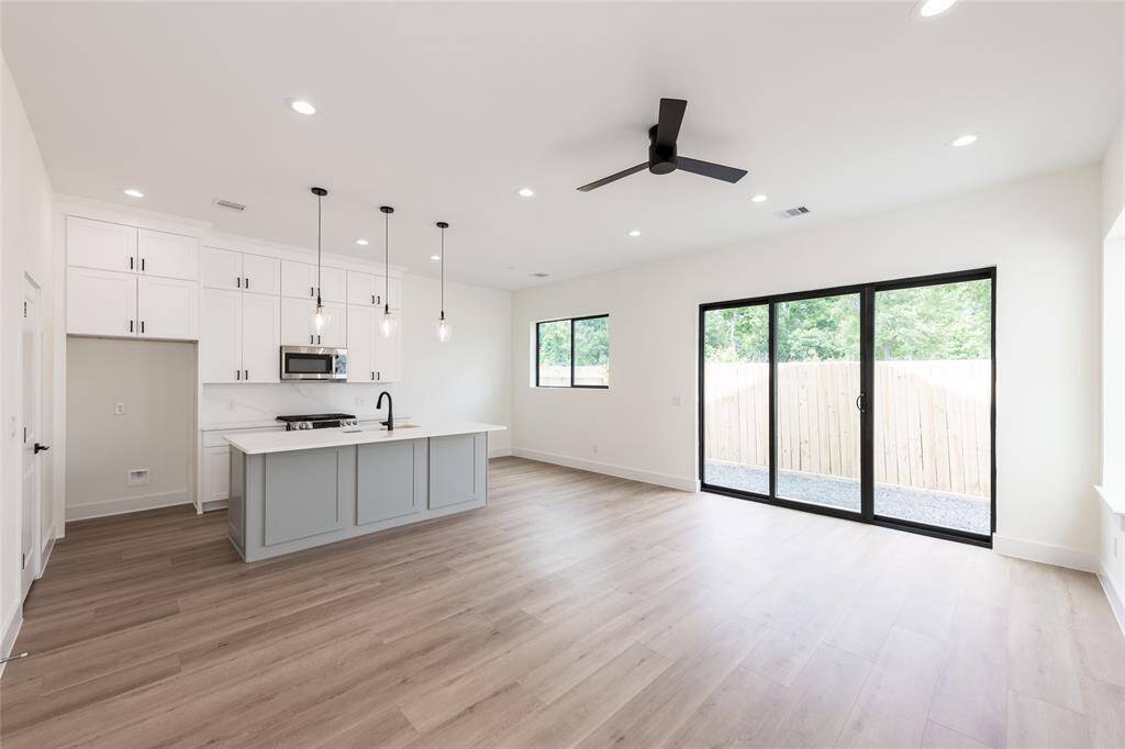 Another angle of the open-concept kitchen and living area, highlighting the sliding glass doors that lead to your private backyard retreat.